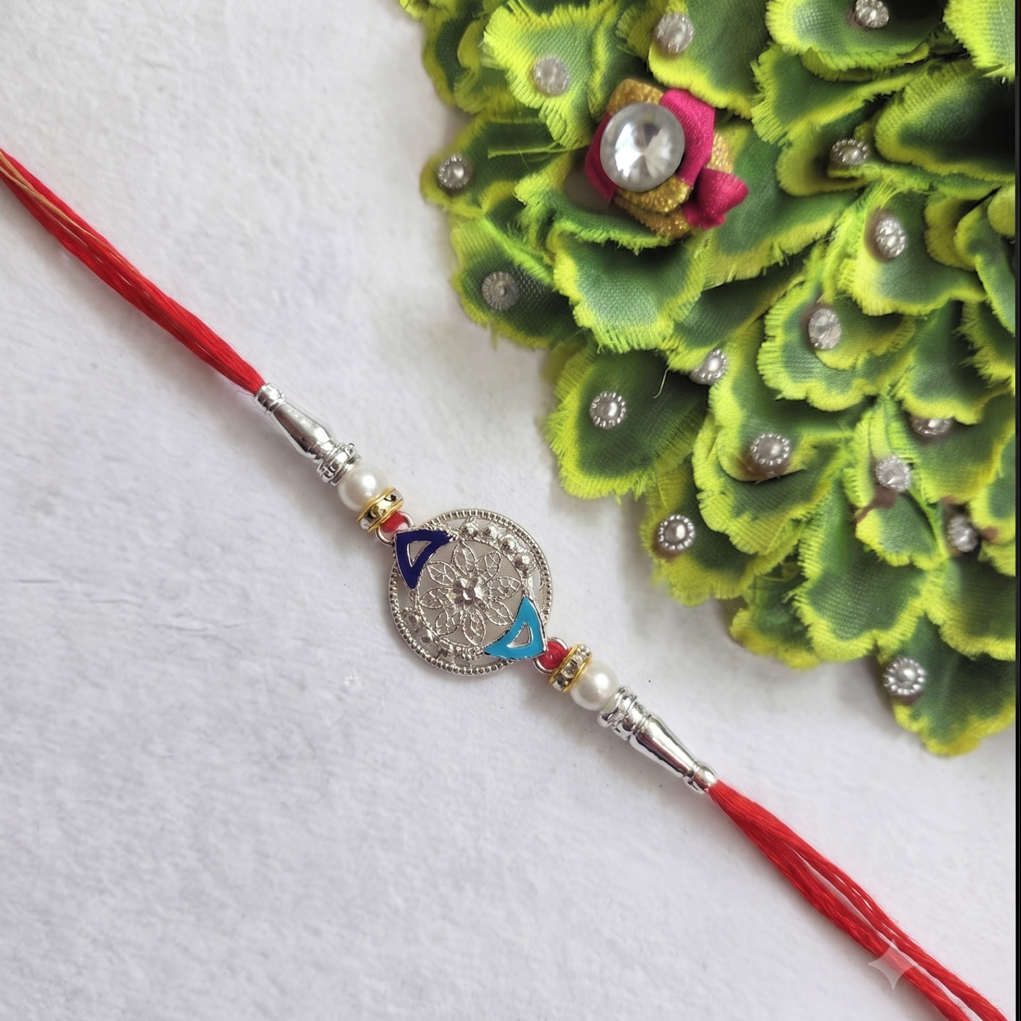 Silver Floral Designer Rakhi with Pearl Accents